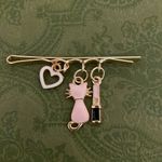 Charming Gold Hair Clip with Pink and Black Charms Photo 2