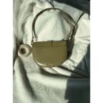 Charles and Keith ’s signature Gabine leather saddle bag Photo 1