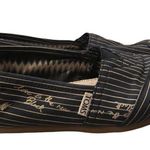 Toms  slipons in navy blue and tan stripes with “Love Is the New Black” quote Photo 0