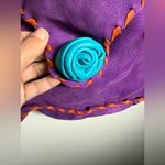 Purple dearskin leather medicine crossbody bag with orange and blue accents. Photo 5