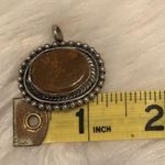 Antiqued silver tone pendant with oval shaped variegated brown stone Photo 4