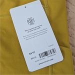 Athleta NWT  ultimate stash 7/8 pocket leggings mustard yellow gold xs Photo 3