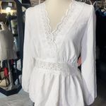 Rose & Grey LOS ANGELES white lace V-neck long sleeve shirt top peplum tie cuff  New with tag  Smoke and pets free  Same day shipping Elevate your wardrobe with this stunning white lace blouse from . The V-neckline and long sleeves add a touch of elegance to this top, while the peplum and tie cuff details create a flattering silhouette. The angel character and rose theme make it perfect for any occasion, from casual outings to formal events.   Crafted from high-quality lace fabric, this blouse features adjustable features and is available in size S. The solid pattern and delicate lace accents make it a versatile piece that can be paired with any bottom. Whether you're dressing up or down, this  blouse is sure to turn heads. Photo 0