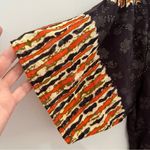 Deep Exports, featuring black background with orange and white circular patterns Size L Photo 4