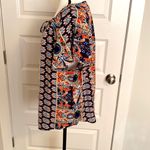 Angashion | Navy/burnt orange print short sleeve scoop neck top with tie accent. Photo 2