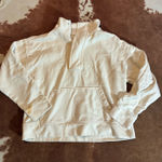 A New Day white cropped quarter zip size medium Stain on sleeve! I have washed it 2 times but I have done nothing else to try to remove the stain possibly could come out if you know how to deal with it?! Photo 0