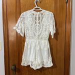 Vestique white lace plunge romper size small. Photo 3