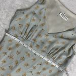 Alyn Paige Long Dress: Elegant 90’s sleeveless dress features A-line silhouette, perfect for any occasion. The delicate fabric drapes beautifully, providing a flattering fit. This timeless piece can be dressed up or down, making it a versatile addition to your wardrobe. Ideal for summer gatherings or evening events, it's a must-have for style enthusiasts. Photo 5