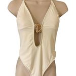 Plunge halter neck thong one piece swimsuit with metal shell medallion cream ivo Photo 0