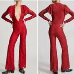 Free People jumpsuit. Red lace w/ deep V & shoulder detail. Color-red size small Photo 1