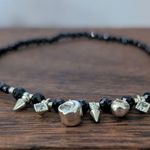 Thin Black Stretch Bracelet with Gold Tone Charms Photo 3