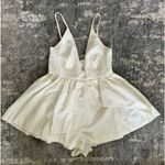 San Joy  Deep V Neck Low Cut Asymmetrical Ruffle Romper Dress in white Photo 4