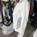 Arena windbreaker full zip jacket raincoat long sleeve tie cuff white grey NWT  New with tag  Same day shipping  Smoke and pets free  This  windbreaker jacket is perfect for outdoor enthusiasts who want to stay comfortable and stylish in any weather. The adjustable tie hem and full zip closure and water-resistant feature make it a great choice for rain or shine. The jacket has a short length with a tie cuff, and the white and grey color combination with the logo accents give it a trendy look.   The jacket is made of 100% polyester and is available in men size XS/ woman size M. It is suitable for both men and women, making it a versatile piece for any wardrobe. Whether you're running errands or hitting the trails, this  windbreaker is the perfect choice. Photo 1