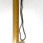 Mayan design gold tone pendant purchased in Costa Rica, on brown suede cord Photo 10