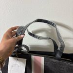 Bebe NWT  Black Tote with Pink Stripes with Matching Wristlet Pouch 16 W x 13 H Photo 4