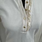 Tory Burch Emily Ruffled Pique Polo Shirt in Ecru. Photo 2