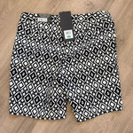 Mario Serrani Stylish bermuda shorts with a bold geometric design. Perfect for casual wear. NWT   Brand:  Italy • Material: A comfortable stretch blend, 76% rayon, 21% nylon, and 3% spandex. • Design: Feature a built-in tummy control panel for a flattering fit, front side seam slanted pockets, a zipper fly with a hook-and-bar closure, and faux back pockets. • Inseam: 9-inch inseam. - Length 18 inches  • Pattern: The shorts  feature a distinct black and white geometric or diamond print. Photo 0