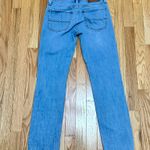 Lucky Brand This product is a pair of  women's boot cut jeans in size 4 with a medium wash. They are made from a cotton blend denim fabric in a solid blue color. The jeans feature a zip closure and a classic 5-pocket design, making them a stylish addition to any wardrobe. With a regular fit and machine washable care instructions, these jeans are perfect for year-round wear. Photo 1