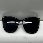 Stylish black sunglasses with gold accents. Photo 0