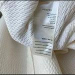 Free People 🆕 Sing La La Scoop Neck Sleeveless
Asymmetrical Hem Knit Ivory TankXS Photo 9