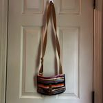 Fossil multicolor purse with adjustable strap in GUC. One small tear on bottom. Photo 1
