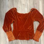 Orange velvet blouse with puffed sleeves and ruched detail # Photo 1