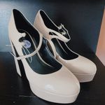 Guess Women's Callyna Platform Round Toe Mary Janes Pump Nude Beige Size 8.5 NEW New with tag Same day shipping Smoke and pets free Slay your elegant look wearing the Callyna platform pump making accent to any ensemble. Patent synthetic upper Adjustable double buckle straps closure Round toe Synthetic lining 4” heels, 1.5" platform, 5.5" covered block heel Synthetic sole Elevate your shoe game with these Women's Callyna Platform Round Toe Mary Janes Pumps in Nude Beige. These patent leather pumps boast an ultra-high block heel and a platform sole, providing both style and comfort. The round toe and adjustable buckle strap make for a perfect fit, while the ivory color and solid pattern make them versatile for any occasion. These women's size 8.5 heels feature the iconic character Marie and are a new addition to your wardrobe, ready to take on the town. Photo 8