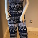 New Women’s dark Navy Blue jumpsuit size L/XL for size 14 New with tags Straps are adjustable Stretchy with front pockets Photo 1