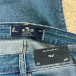 Hollister New with tags  low rise boot cut blue jeans in size 20s or 35 short Photo 4