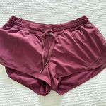 Lululemon   maroon lined drawstring shorts with reflective striped sides   Photo 0