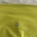 Lululemon women's high-rise leggings in neon yellow. Stretchy, Size 12 Photo 4