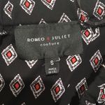 Romeo + Juliet Couture Off the shoulder romper, black red and white. Photo 1