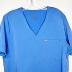 FIGS  Technical Collection 2-Pocket Blue Scrub Top Women’s Size XS Photo 1