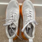 Nobull Journey running shoe in white with an orange midsole Photo 0