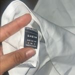 SheIn White Sleeveless Blouse with Bold Buttons Photo 2