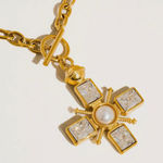 Chunky gold cross necklace with pearl and toggle clasp Photo 1