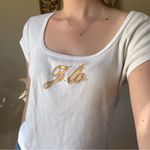 Jennifer Lopez White Tee with Gold Accents Photo 5