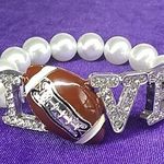 Ladies' NWOT "L🏈VE" Bejeweled Stretchy Bracelet Photo 0