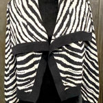 Say What? Say What? black/gray crop animal pattern cardigan sweater. Size medium. ***Refer to measurements as size tag removed. Gently warn & excellent condition. Beautiful. Measurements approximately 18” from armpit to armpit x 15” long. Non-smoking home. Priced at as is condition. Don’t like my price make a reasonable offer! And thank you for checking my closet! Photo 0
