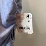 Free People  Ruffle Me Away Slim Fit Plunge Neck Top Blue Heron Photo 5