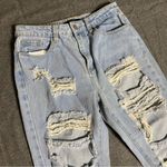 Forever 21 Ripped Jeans Light Wash, torn leg, elastic Ankle, tapered Size small Photo 2