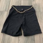 We Wore What  black biker shorts with gold chain belt Photo 3