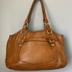 Tan Leather Shoulder Bag with Gold Hardware and Structured Shape Photo 0