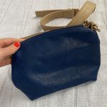 Charming Charlie small blue crossbody bag with tan strap. Photo 10