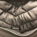 Cynthia Rowley Anthropologie’s Quilted Puffer Travel Bag is a stylish and functional accessory designed for travel enthusiasts. Crafted from high-quality materials, this bag features a quilted exterior for added texture and durability. Its spacious interior provides ample room for belongings, while the thoughtful design includes convenient pockets for organization. The soft puffer style adds a chic touch, making it suitable for various occasions, whether heading to the gym or embarking on a weekend getaway. With comfortable straps for easy carrying, this travel bag combines practicality with fashionable flair. Photo 2