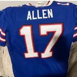NFL Team Apparel Show your support with this Buffalo Bills blue jersey. Perfect for fans, this jersey combines style and comfort. Photo 4