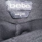Bebe women logo leggings are a size Medium. Photo 2