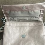 Kipling crossbody purse. Adjustable strap. Flap over closure w/ snap. Light pink Photo 7