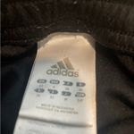 Adidas Black Cropped Pants with Green Stripes Photo 1