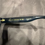 Gucci GG1714S cat-eye sunglasses with a black frame and solid grey lenses Photo 8